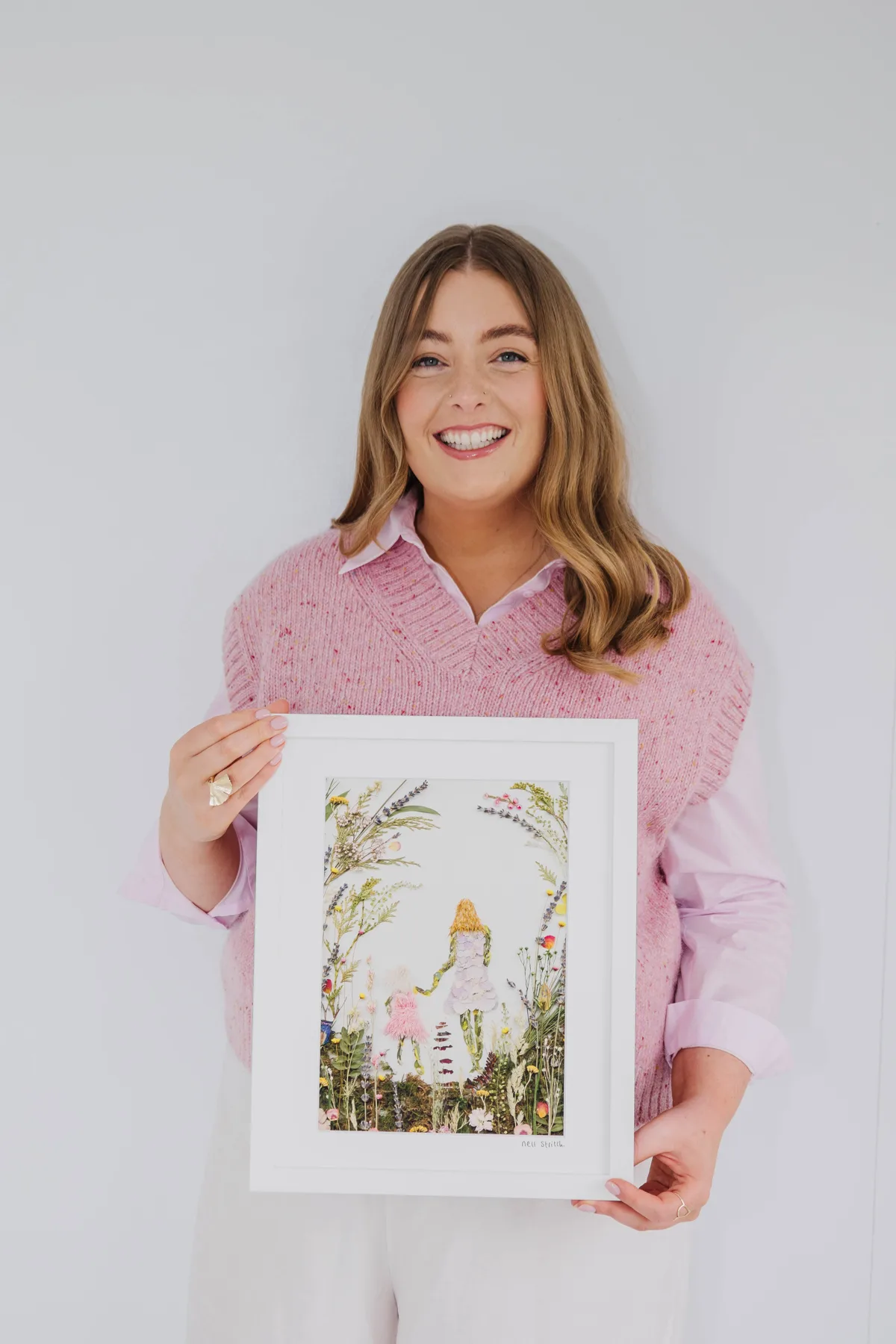 Nell in her studio with her pressed flower artwork