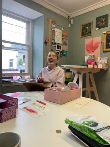 Nell laughing while packing orders in the studio