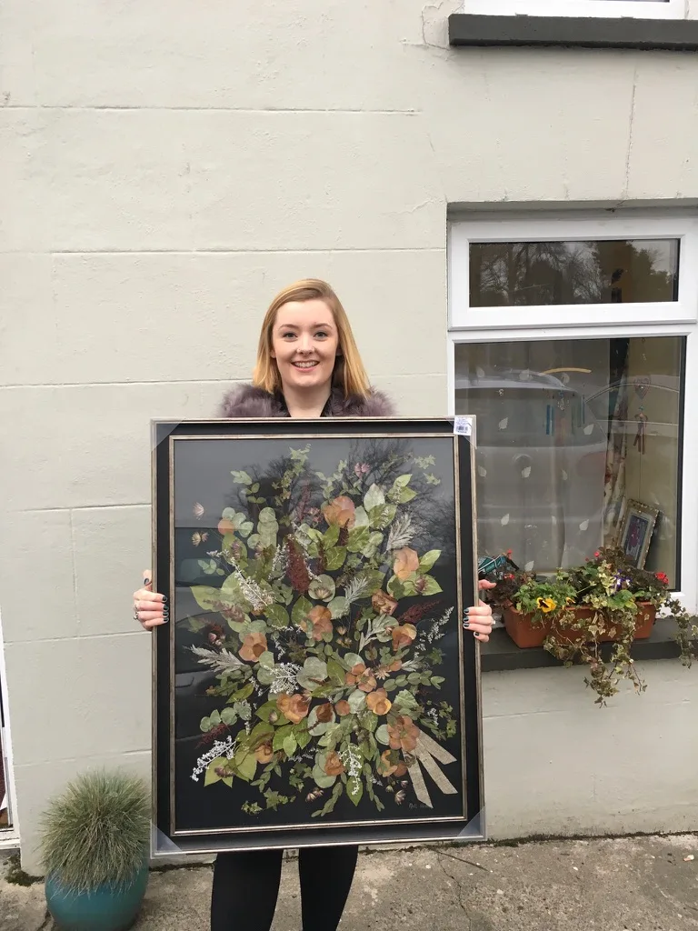 Nell holding one of her early framed pressed bouquets