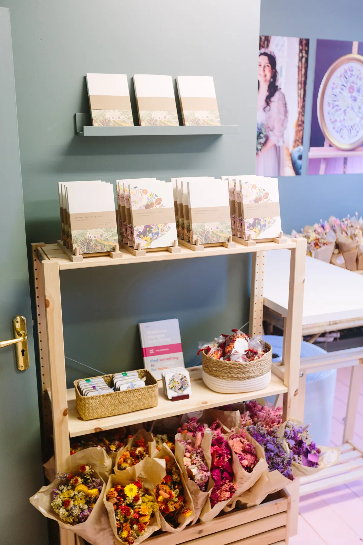 Cards and prints in kraft sleeves on a wooden crate in the studio