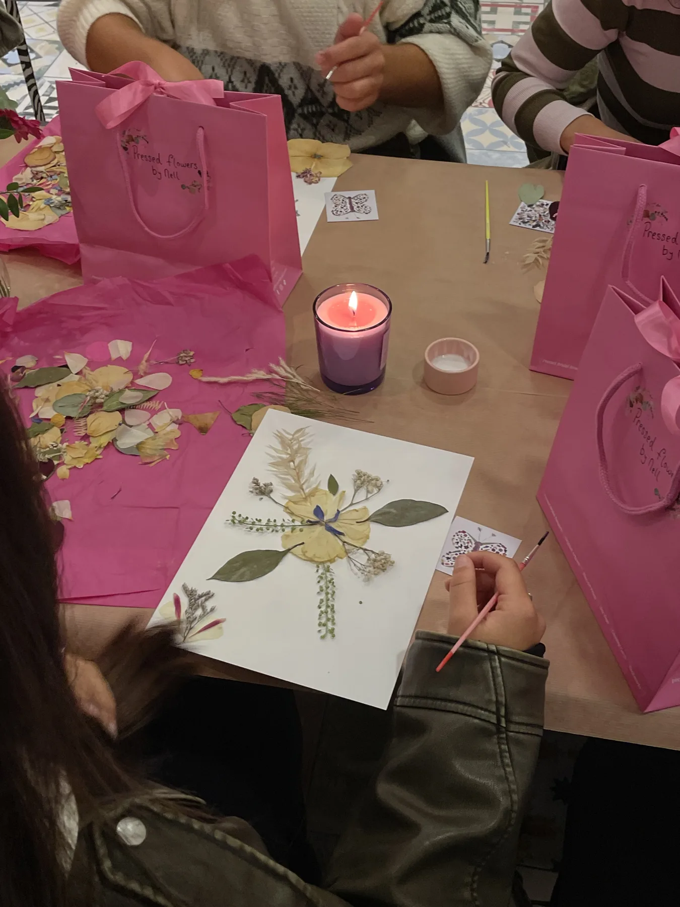 A guest arranging pressed flowers at a workshop