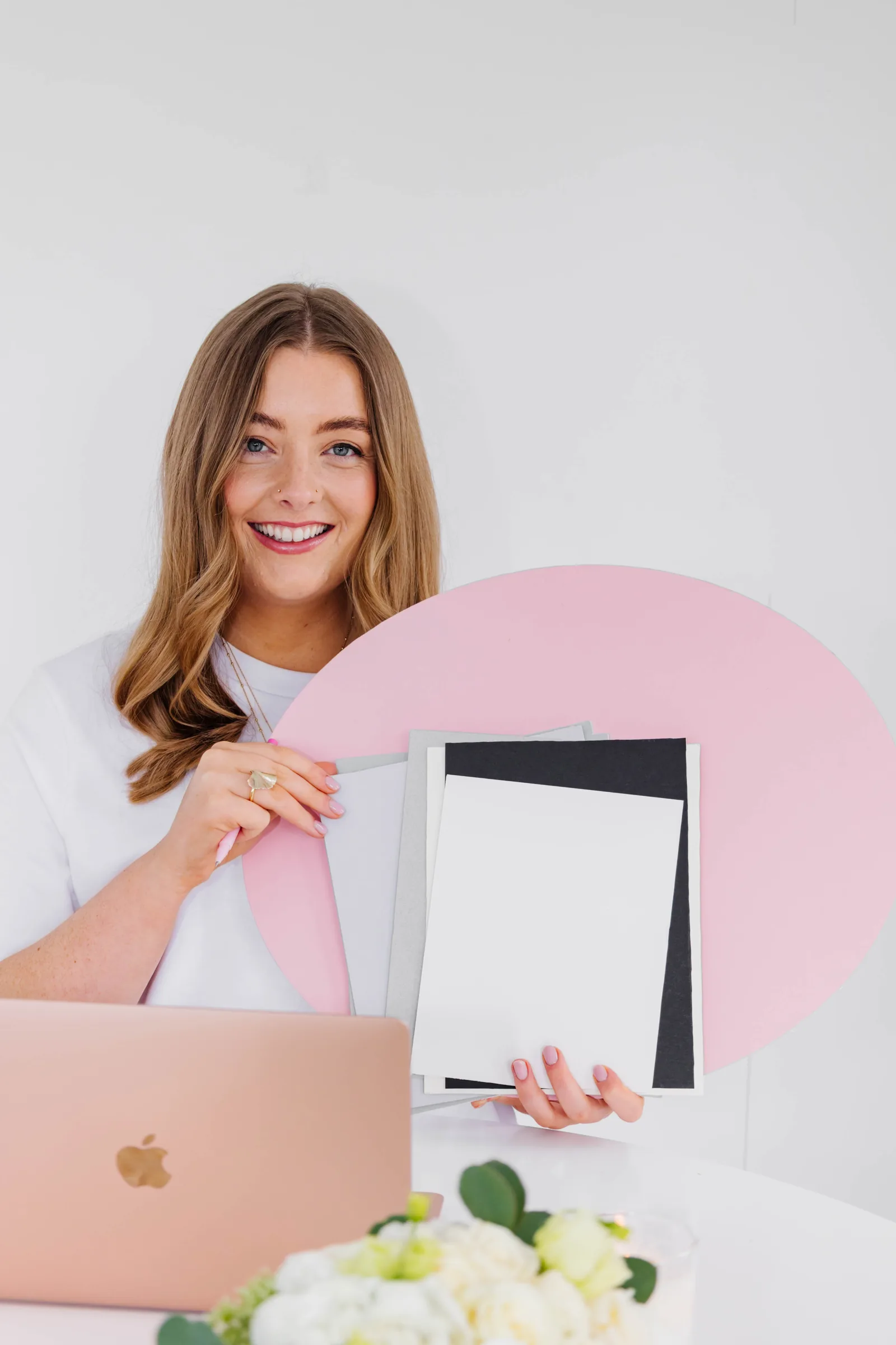 Nell at her laptop in the studio showing frame and mountboard samples