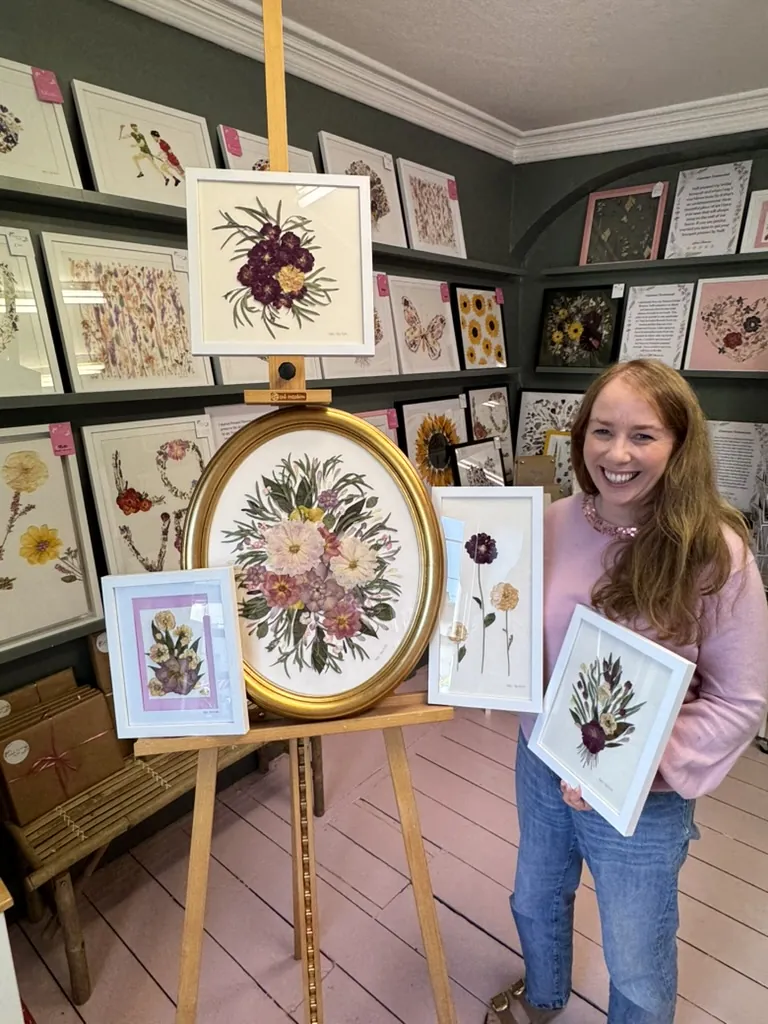 A happy bride with her framed pressed wedding bouquet