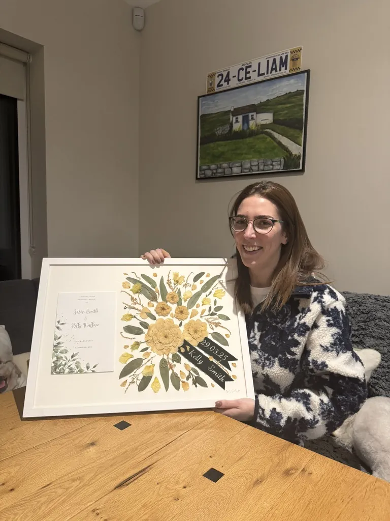 A happy bride with her framed pressed wedding bouquet