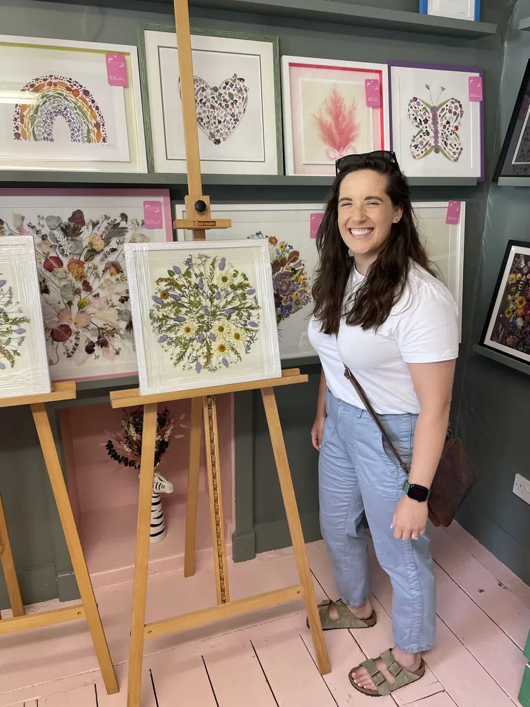 A happy bride with her framed pressed wedding bouquet