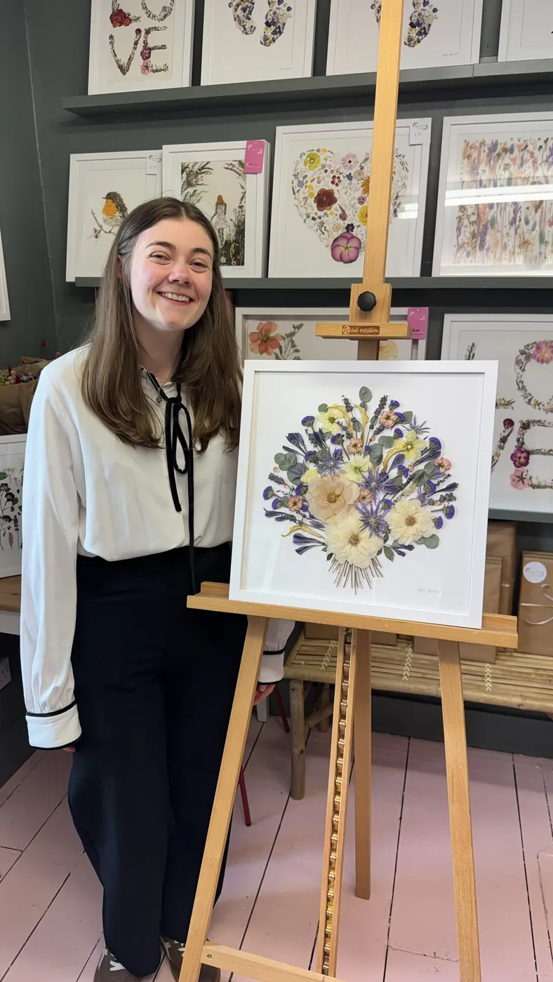 A happy bride with her framed pressed wedding bouquet