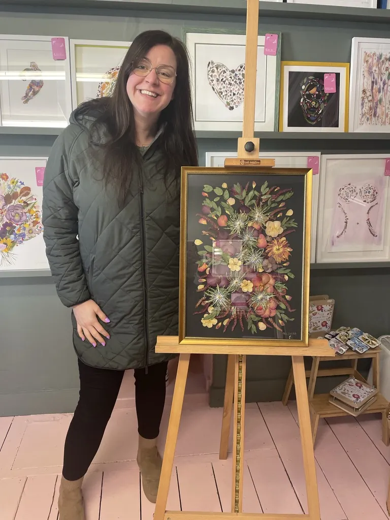 A happy bride with her framed pressed wedding bouquet