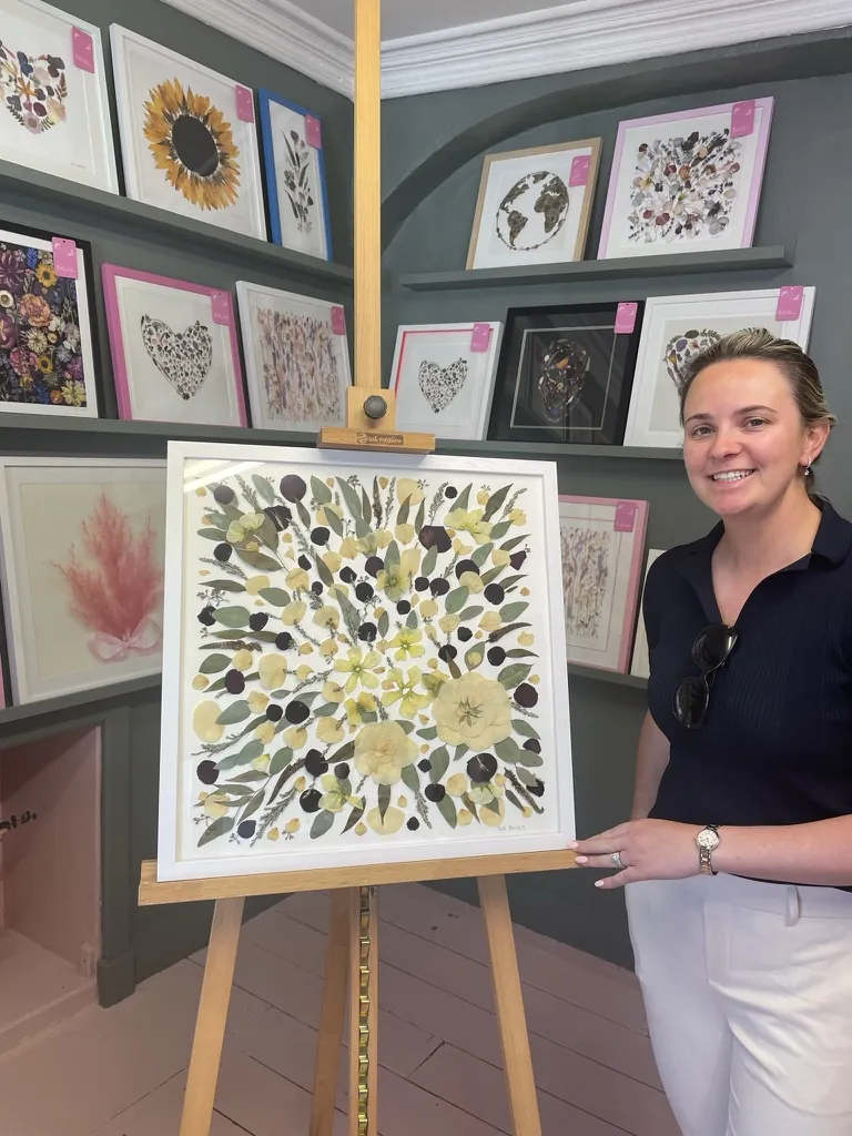 A happy bride with her framed pressed wedding bouquet