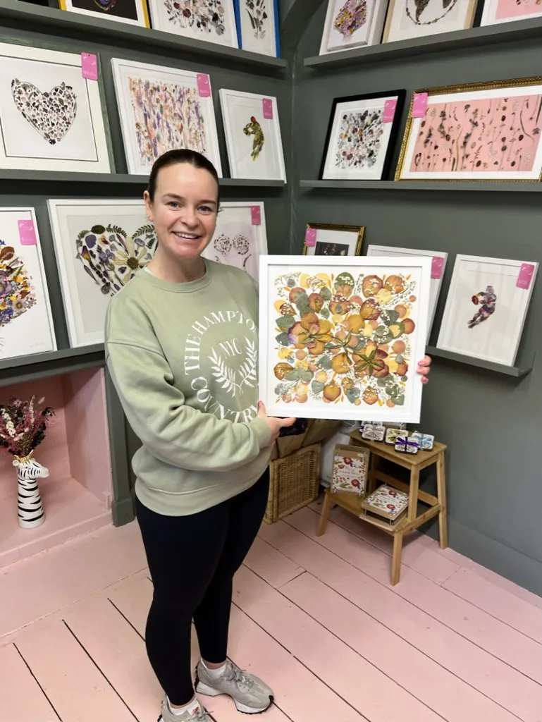 A happy bride with her framed pressed wedding bouquet