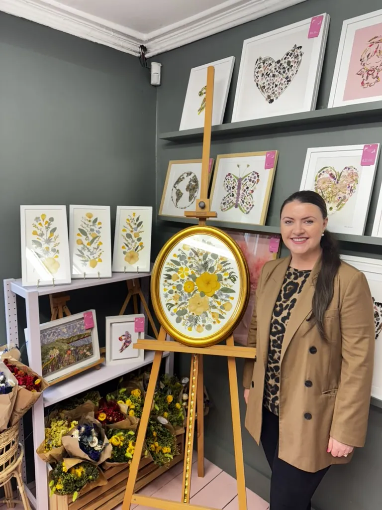 A happy bride with her framed pressed wedding bouquet