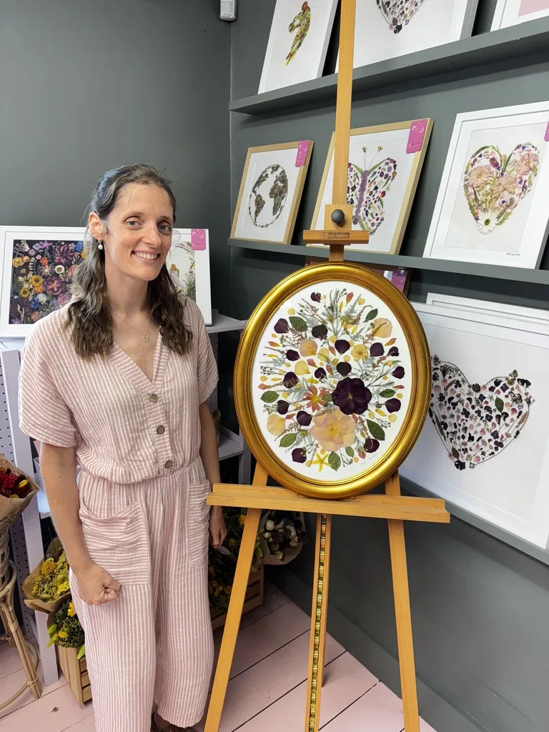 A happy bride with her framed pressed wedding bouquet