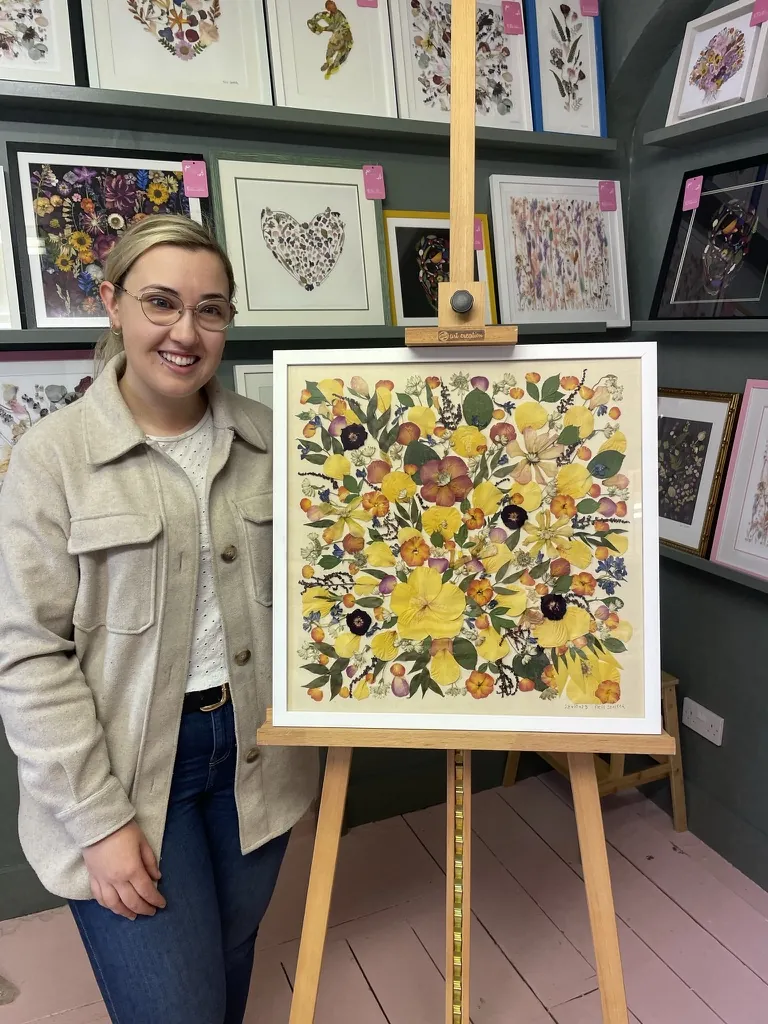 A happy bride with her framed pressed wedding bouquet