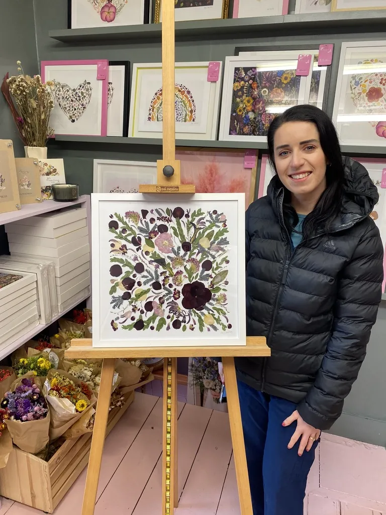 A happy bride with her framed pressed wedding bouquet