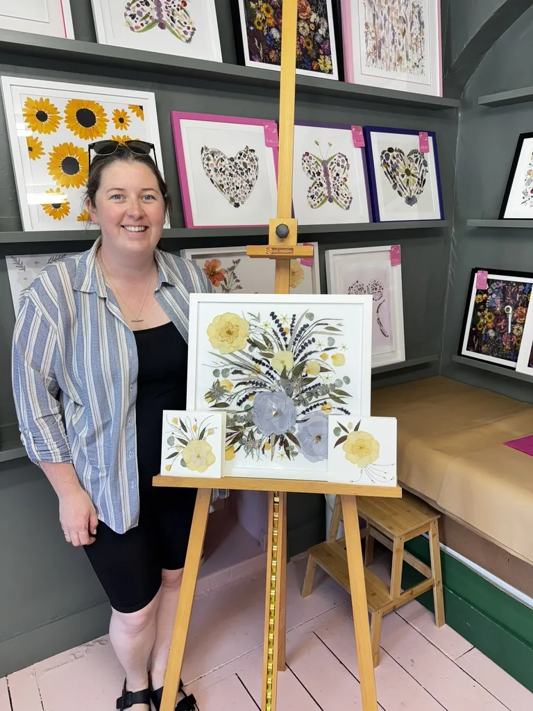 A happy bride with her framed pressed wedding bouquet