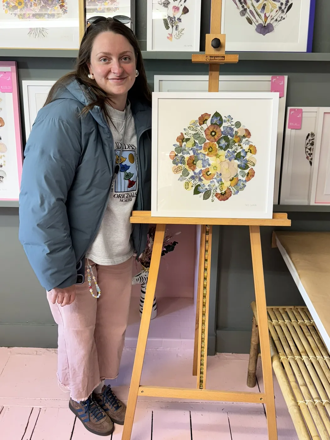 A happy bride with her framed pressed wedding bouquet