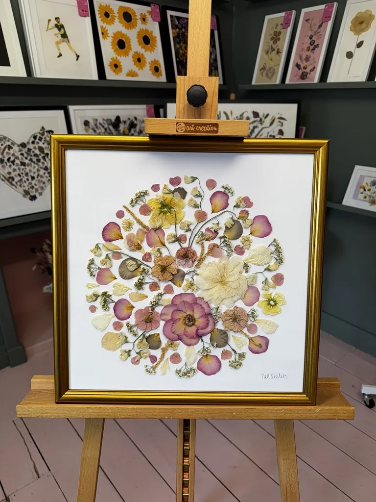 A happy bride with her framed pressed wedding bouquet
