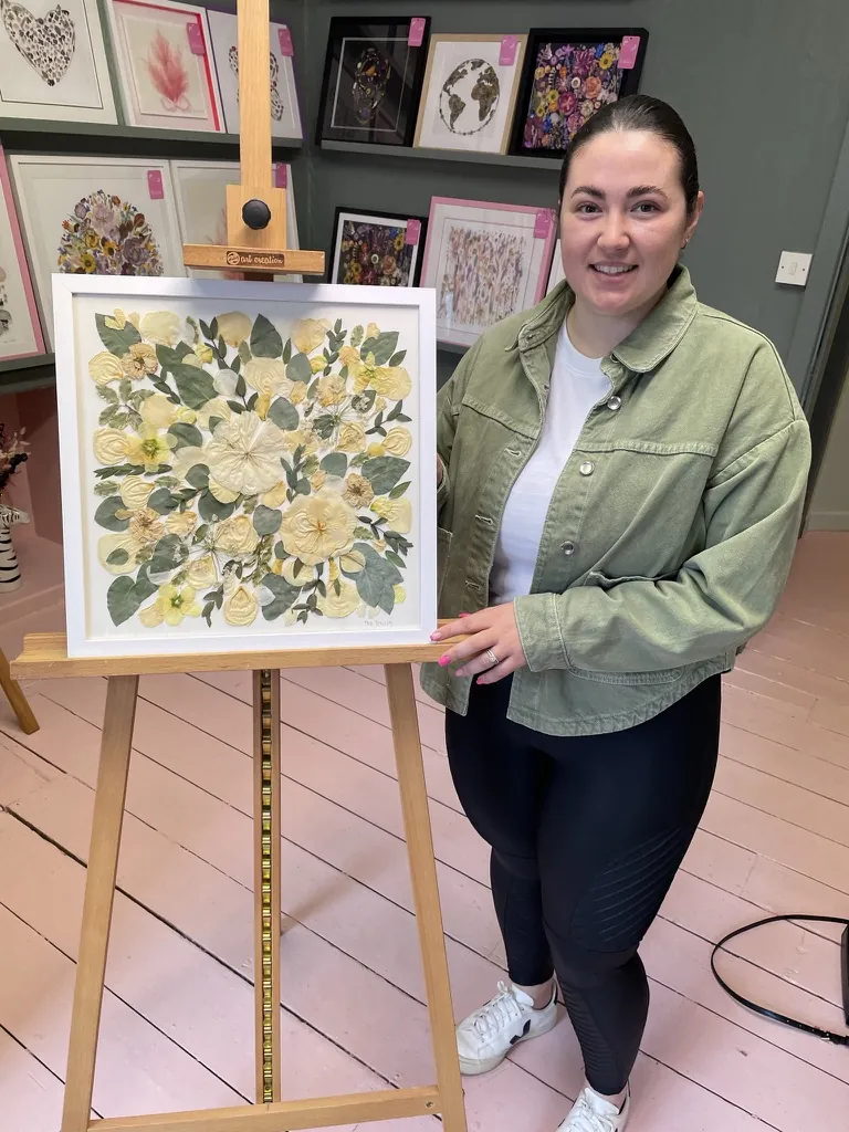 A happy bride with her framed pressed wedding bouquet