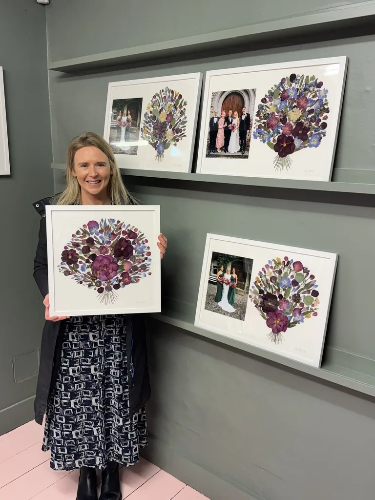A happy bride with her framed pressed wedding bouquet