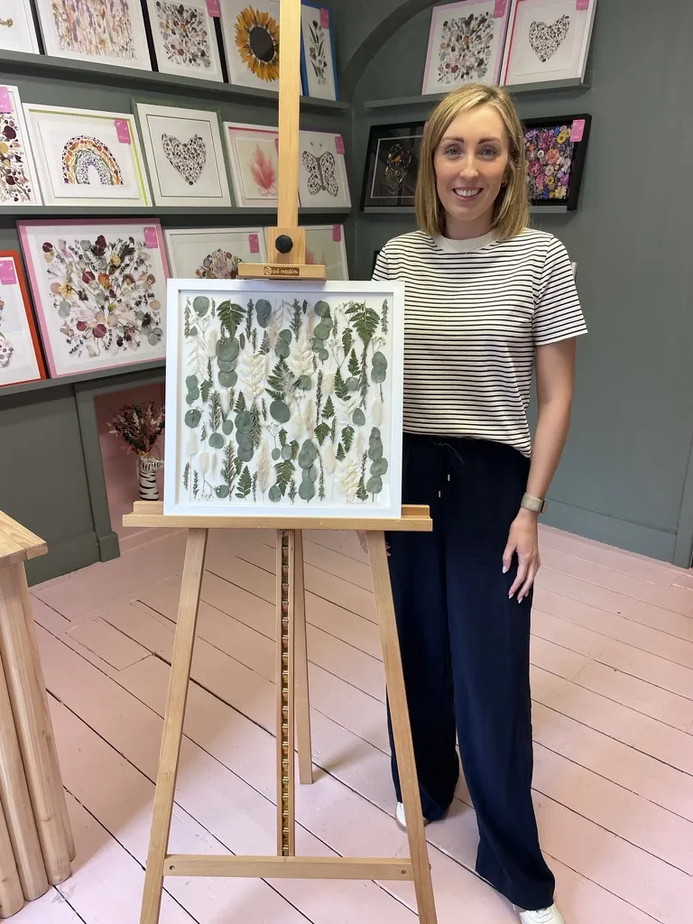A happy bride with her framed pressed wedding bouquet