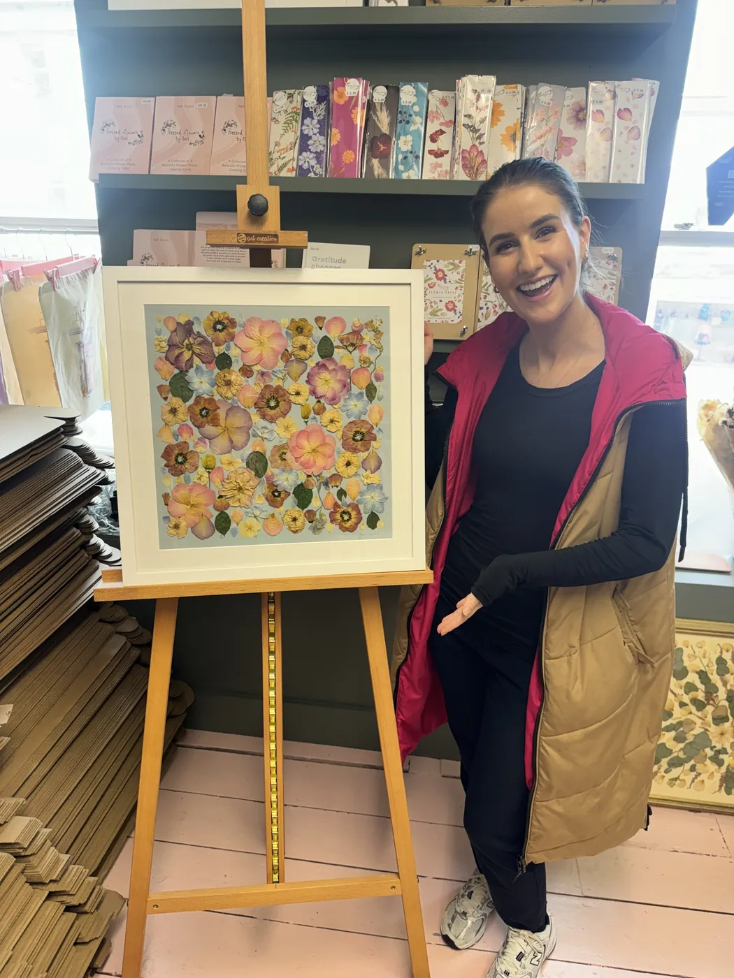 A happy bride with her framed pressed wedding bouquet