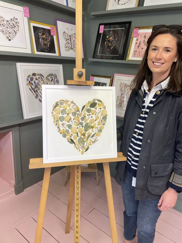 A happy bride with her framed pressed wedding bouquet