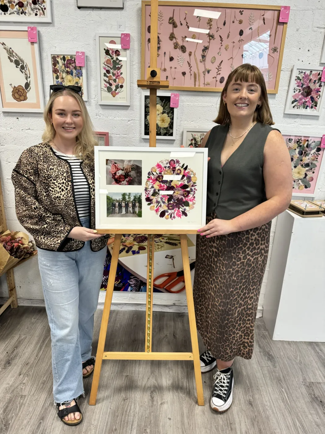 A happy bride with her framed pressed wedding bouquet
