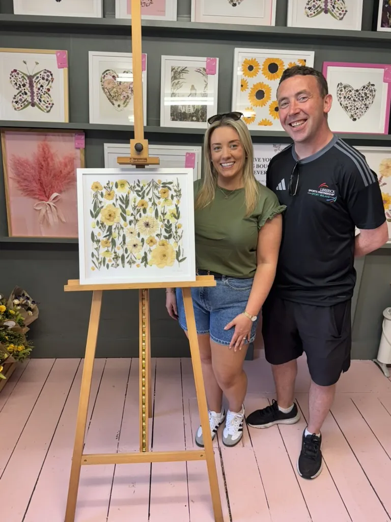 A happy bride with her framed pressed wedding bouquet