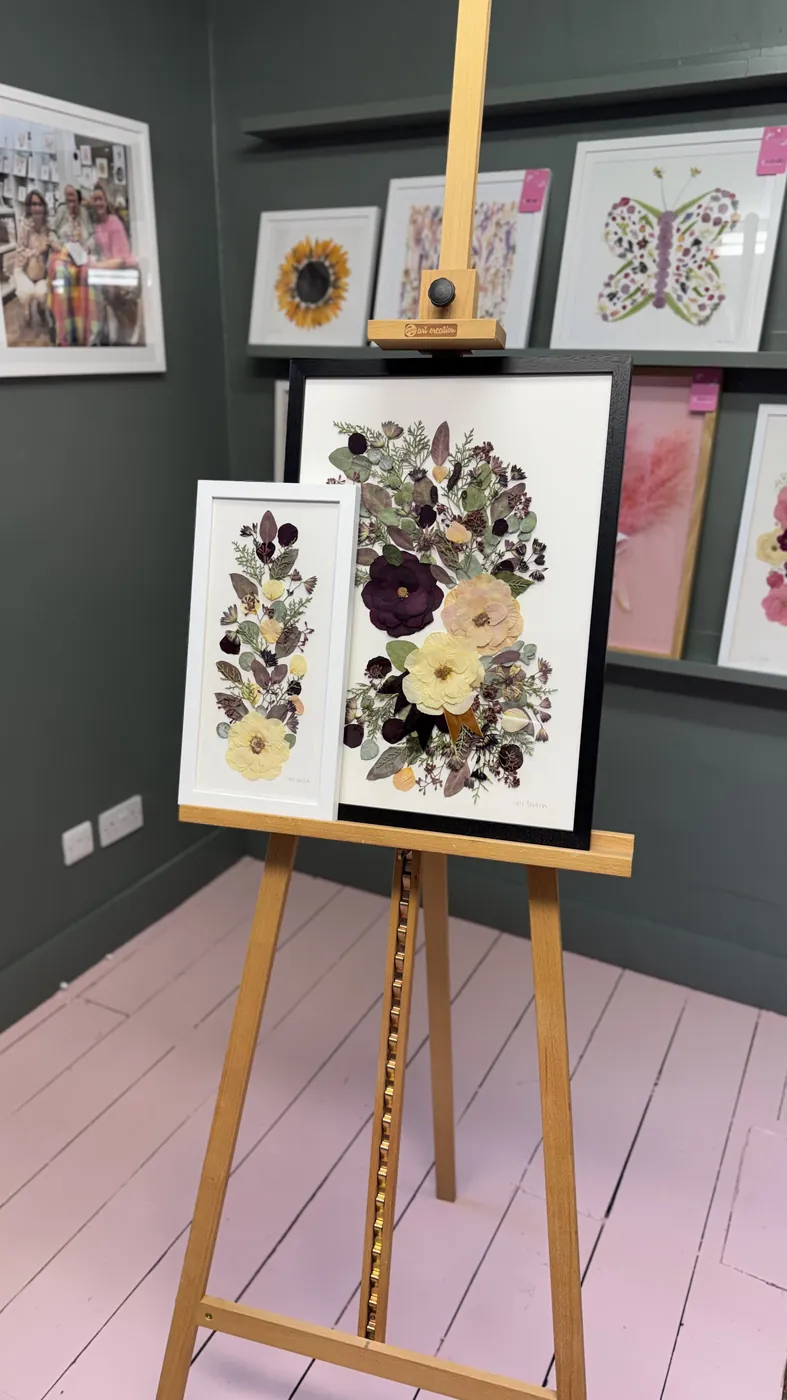 A happy bride with her framed pressed wedding bouquet