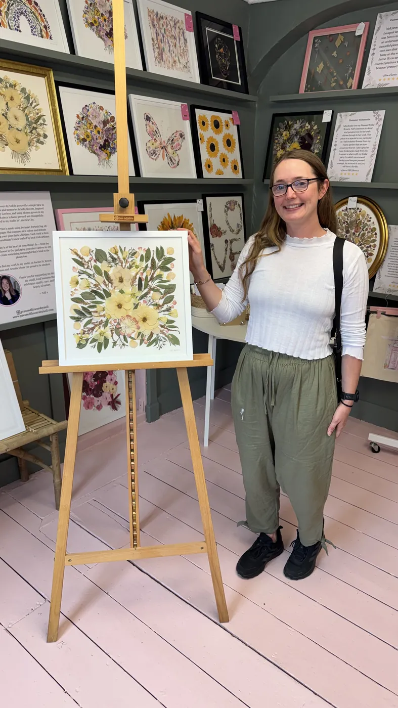 A happy bride with her framed pressed wedding bouquet
