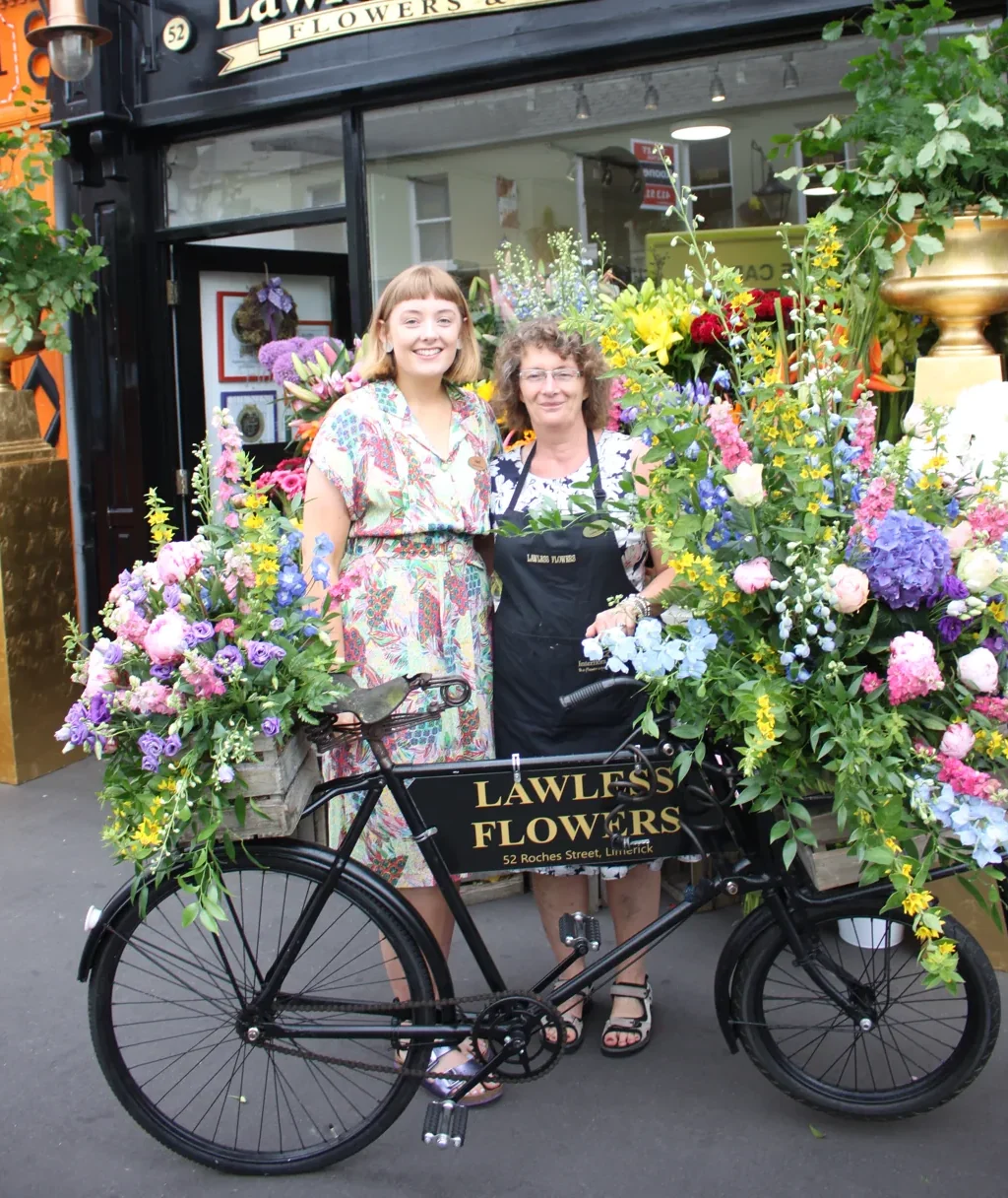 Nell and her mum with the Lawless Flowers bicycle outside Nana Nancy’s flower shop in Limerick