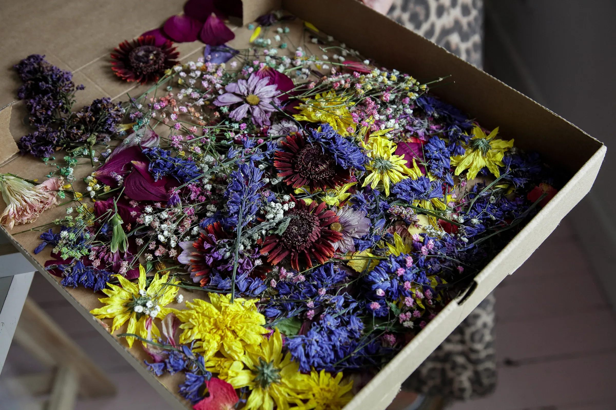 A box of fresh flowers arriving at the studio to be pressed