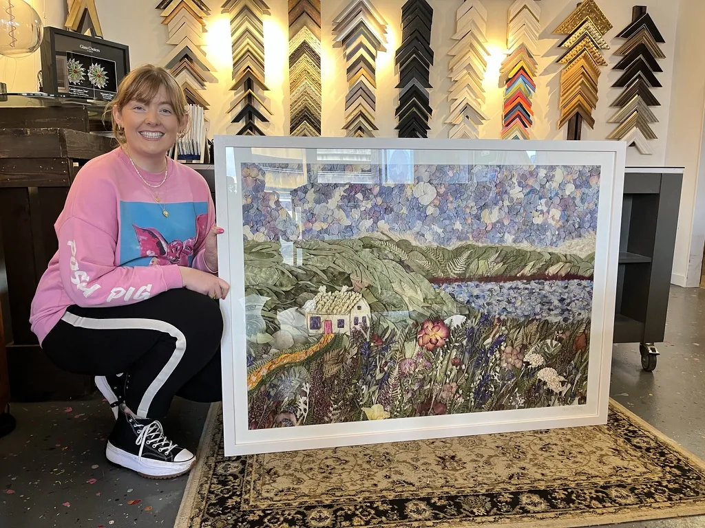 Nell at the Irish framing workshop with a large framed pressed flower landscape