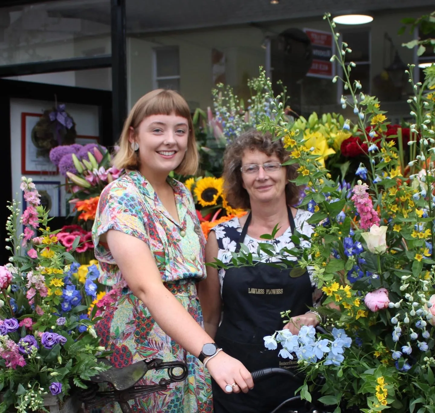 Nell and her mum Helen among buckets of fresh flowers